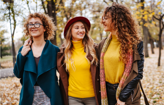 Three friends walking in leaves Three friends walking in leaves