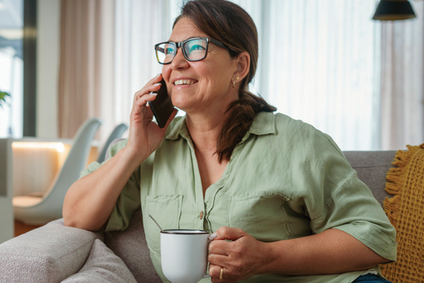 Woman on phone holding coffee cup