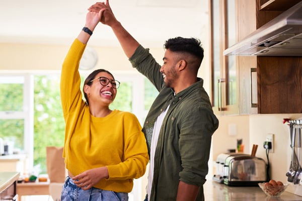 Young couple dancing in kitchen