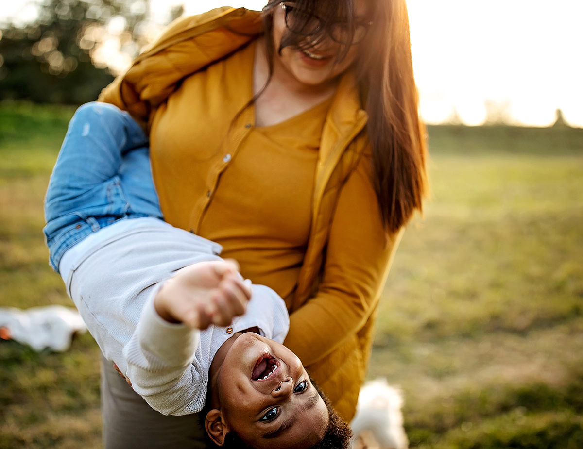 Woman holding boy upside down Woman holding boy upside down